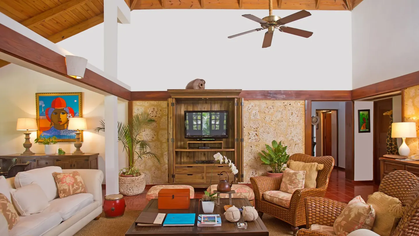 Villa living room with wicker seating and wood ceiling at Casa de Campo Resort and Villas.