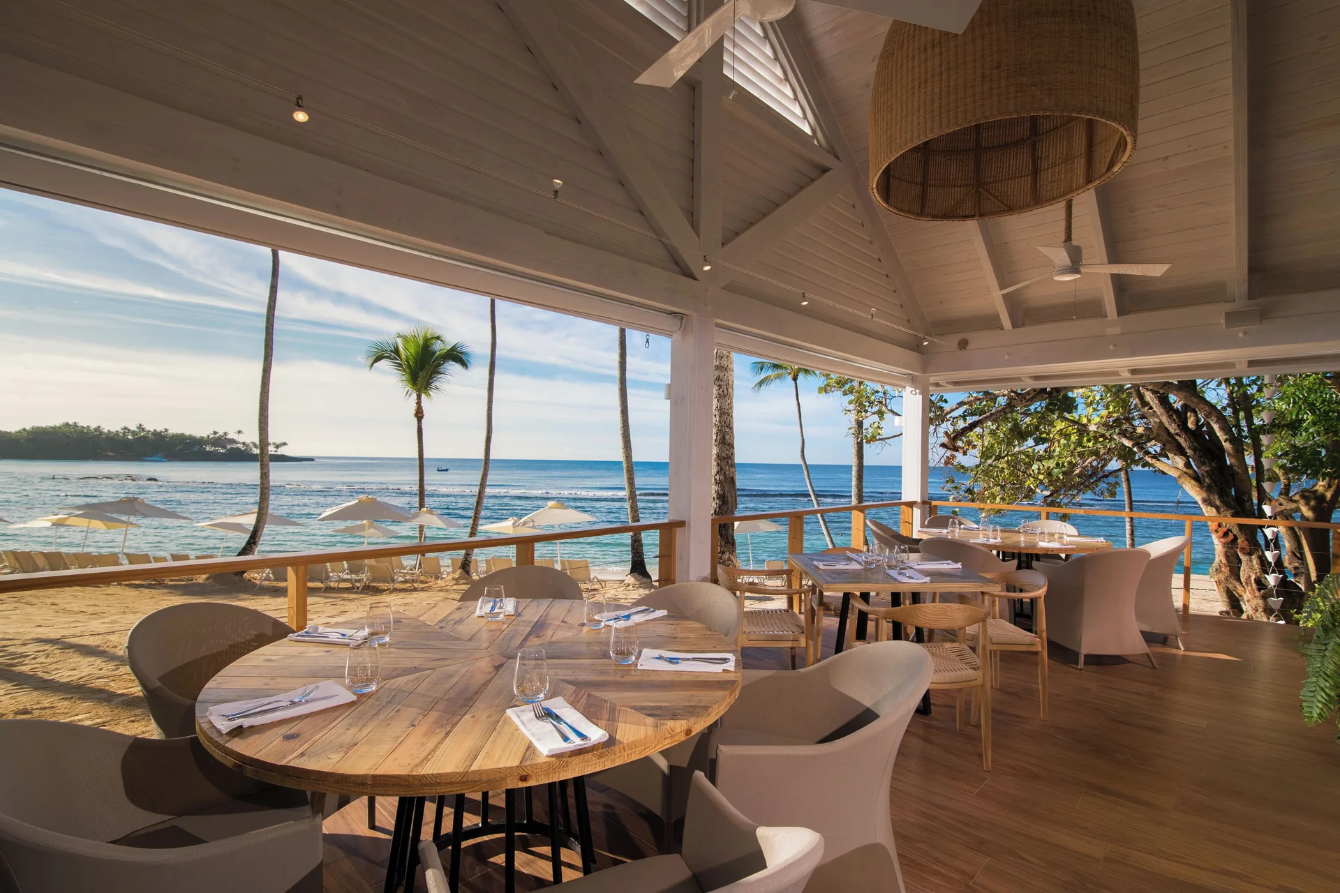 Beachfront dining terrace with ocean views at Casa de Campo Resort and Villas.