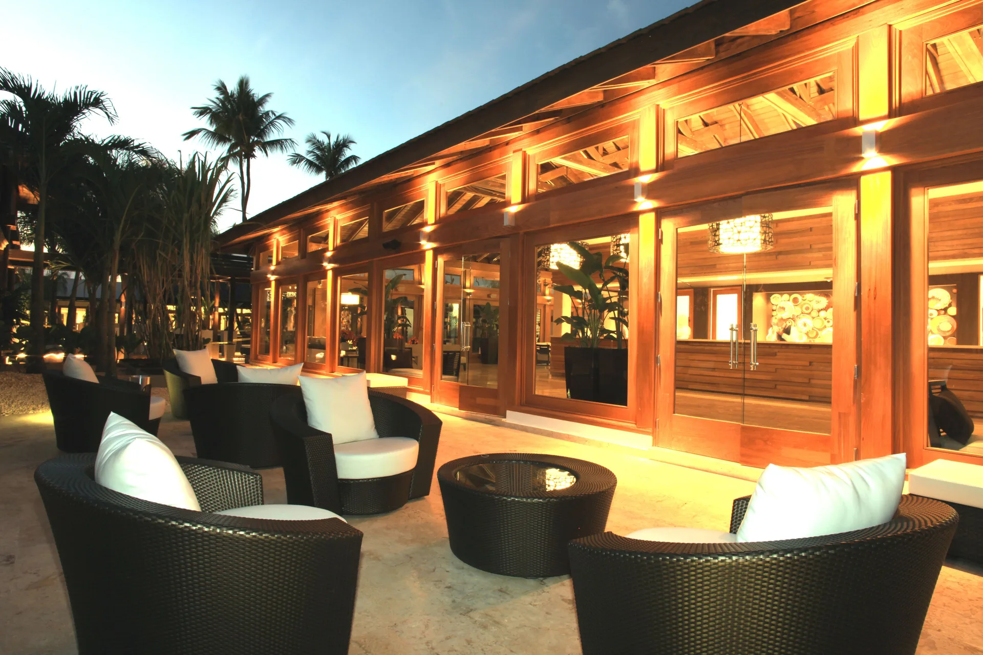 Evening outdoor lounge seating beside a wood-fronted building at Casa de Campo Resort and Villas and Villas and Villas.
