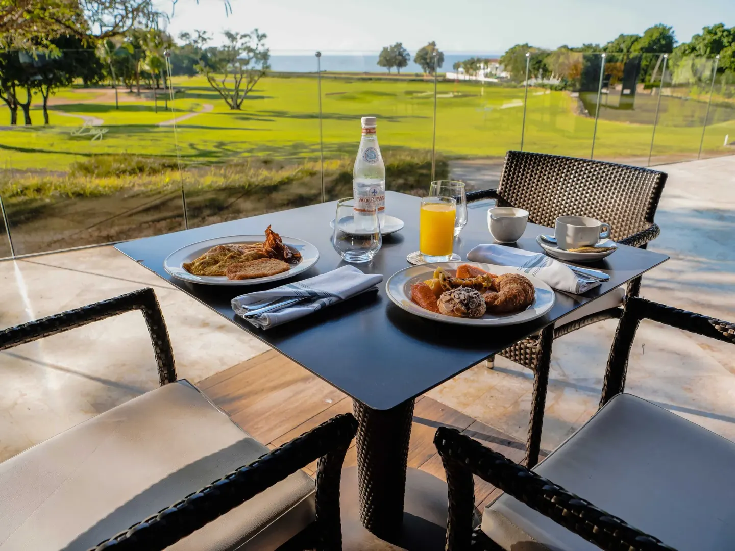 Breakfast table overlooking the golf course at Casa de Campo Resort and Villas.