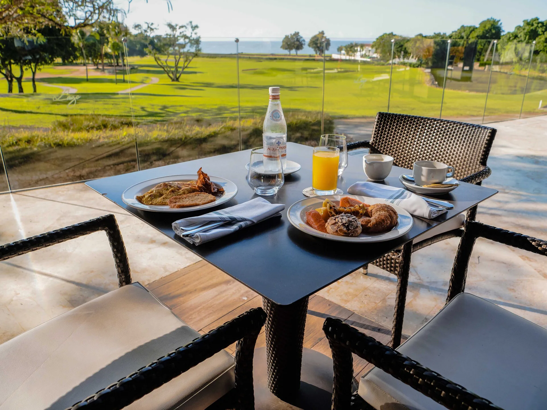 Breakfast table overlooking the golf course at Casa de Campo Resort and Villas.