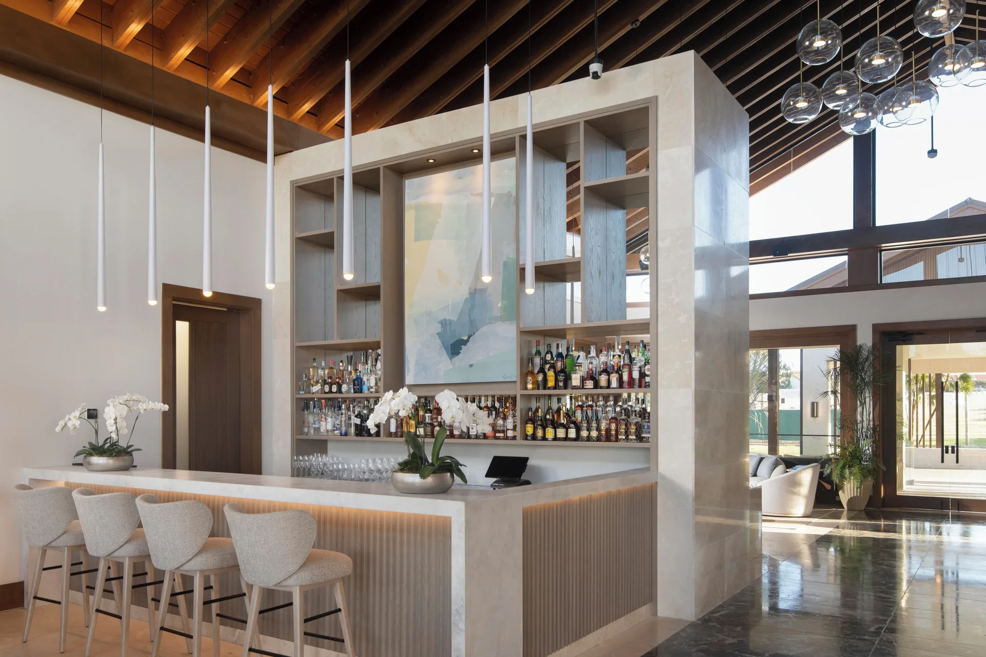 Lobby bar with marble counter and shelves at Casa de Campo Resort and Villas.