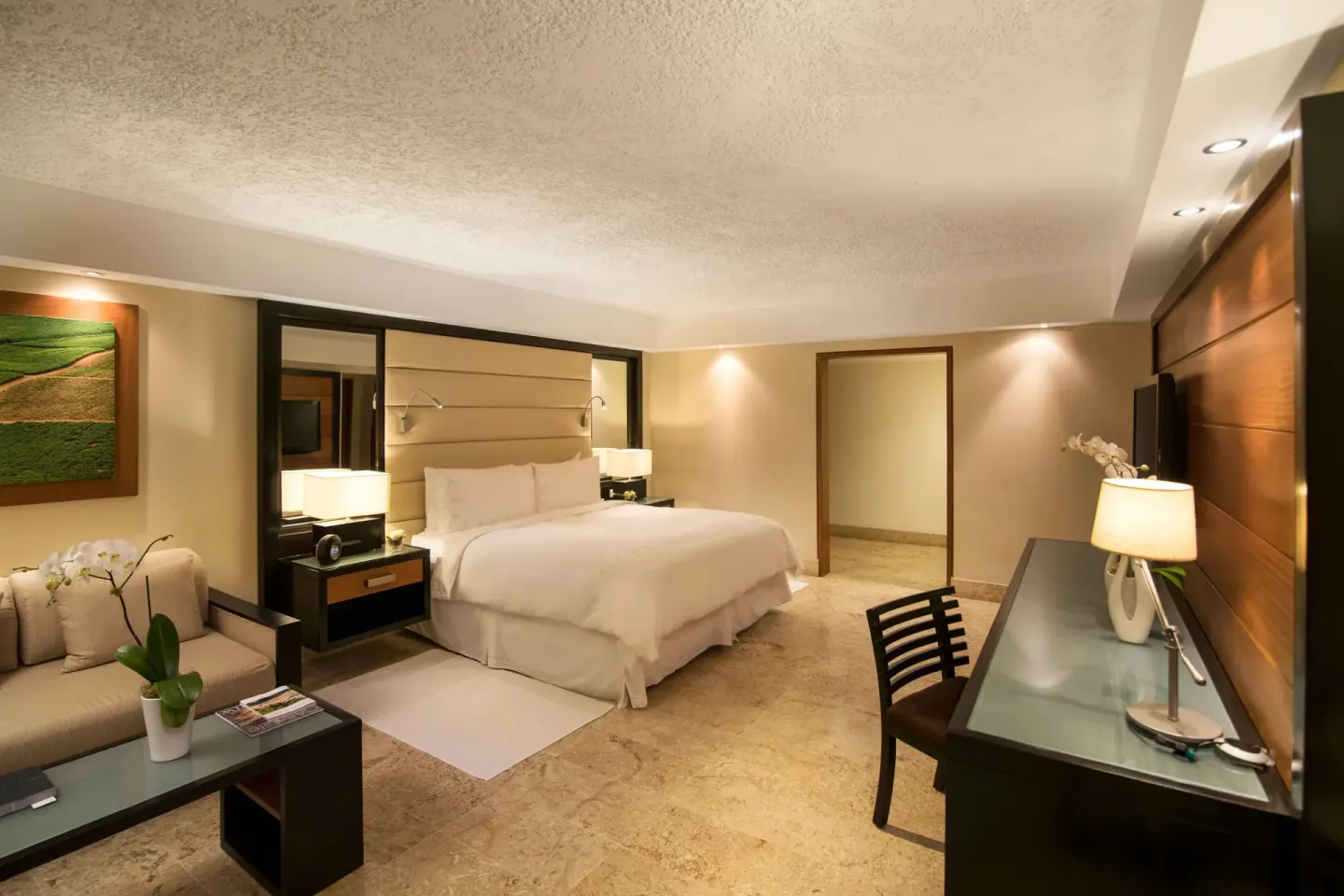 Elite Room king bed and sitting area at Casa de Campo Resort and Villas.