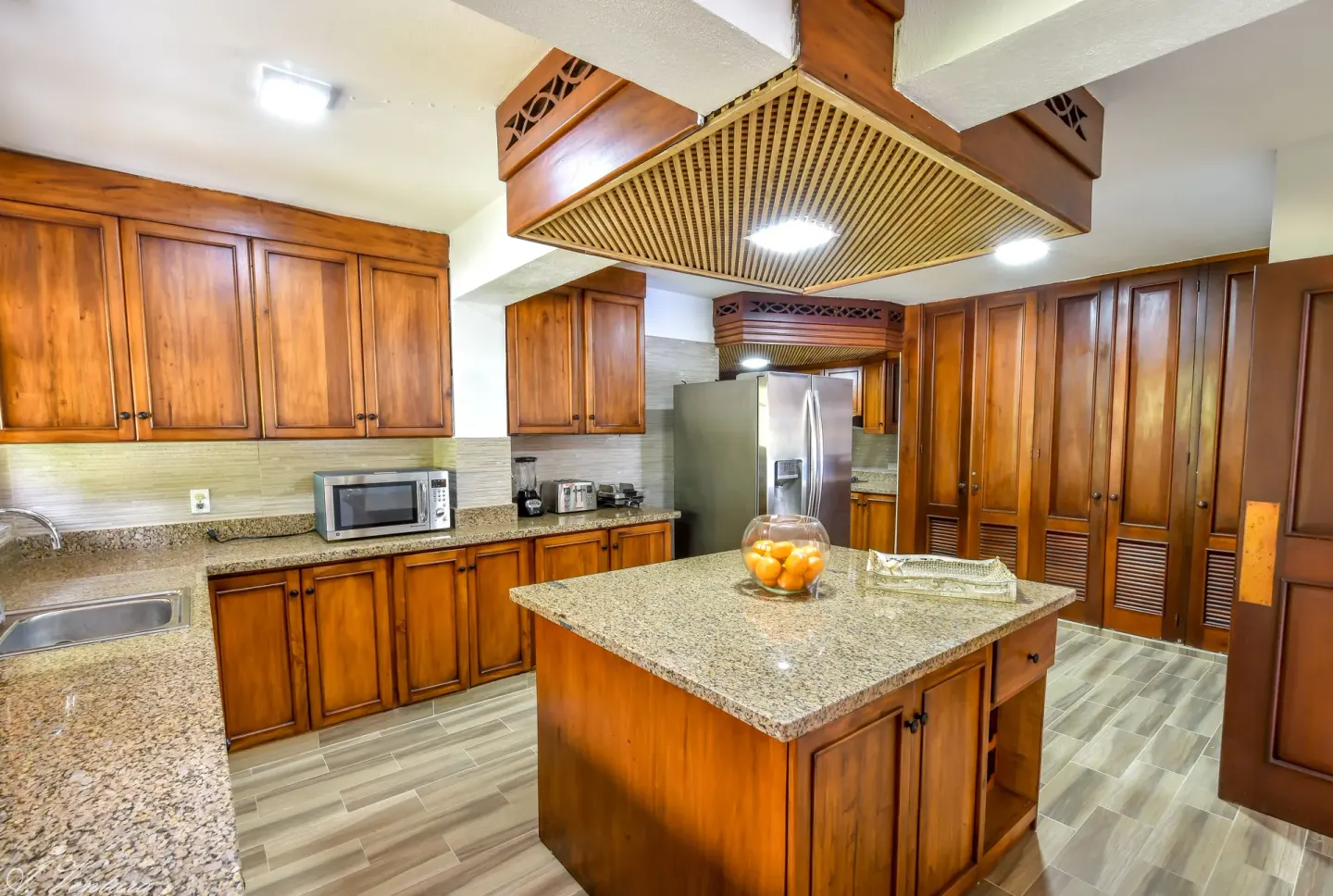 Wood cabinet kitchen in a Five Bedroom Classic Villa at Casa de Campo Resort and Villas and Villas and Villas.