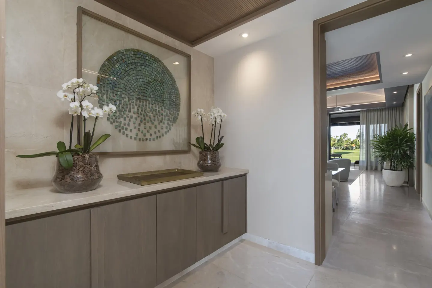 Entry of a One Bedroom Luxury Premier Suite at Casa de Campo Resort and Villas with orchids and artwork.