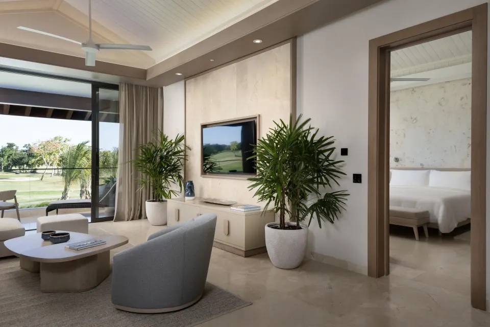 Living area of a One Bedroom Luxury Premier Suite at Casa de Campo Resort and Villas and Villas and Villas with plants and balcony doors