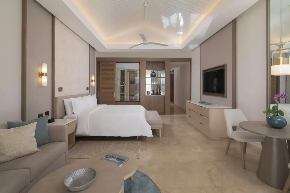 Premier Jr. Suite with Balcony bedroom and sitting area at Casa de Campo Resort and Villas.
