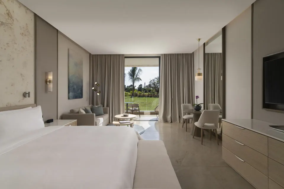 Premier Jr. Suite with king bed and sitting area at Casa de Campo Resort and Villas and Villas and Villas.