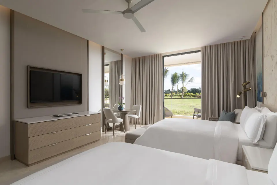 Two double beds in a Premier Jr. Suite with Patio at Casa de Campo Resort and Villas.