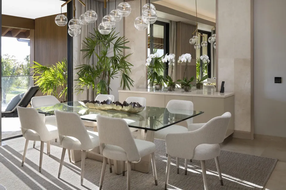 Premier Presidential Suite dining table at Casa de Campo Resort and Villas beside glass doors.