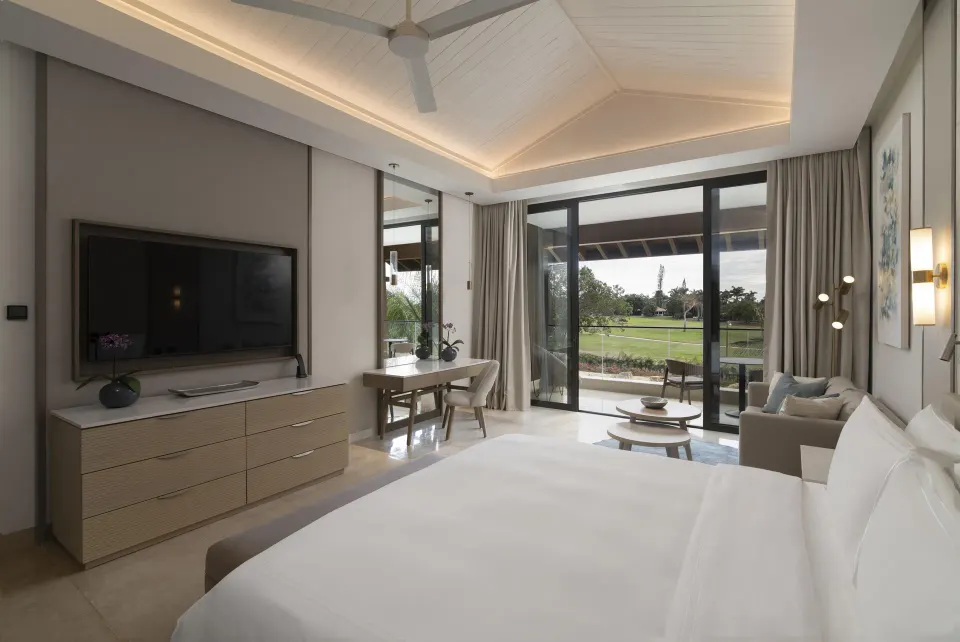 Premier Presidential Suite king bedroom at Casa de Campo Resort and Villas with balcony doors.