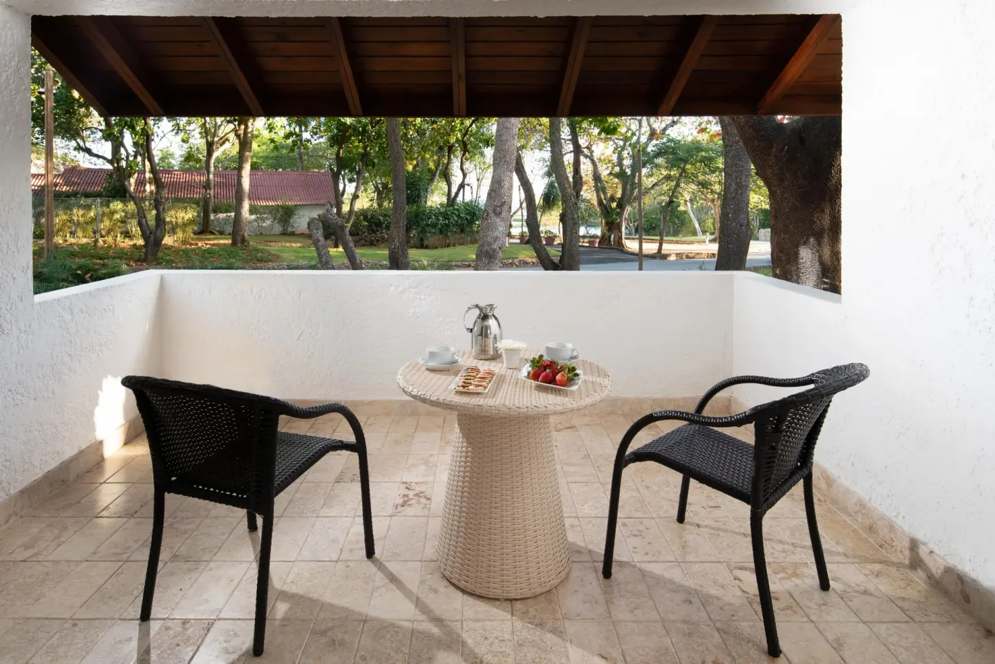 Superior Casita covered terrace with chairs and a table at Casa de Campo Resort and Villas and Villas and Villas.