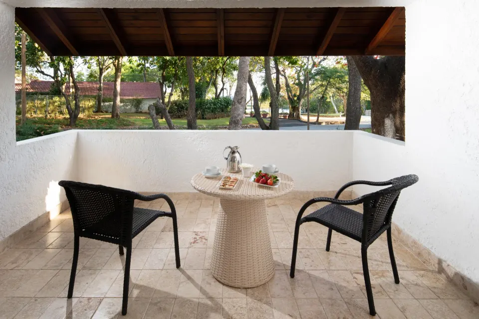 Superior Casita covered terrace with chairs and a table at Casa de Campo Resort and Villas and Villas and Villas.