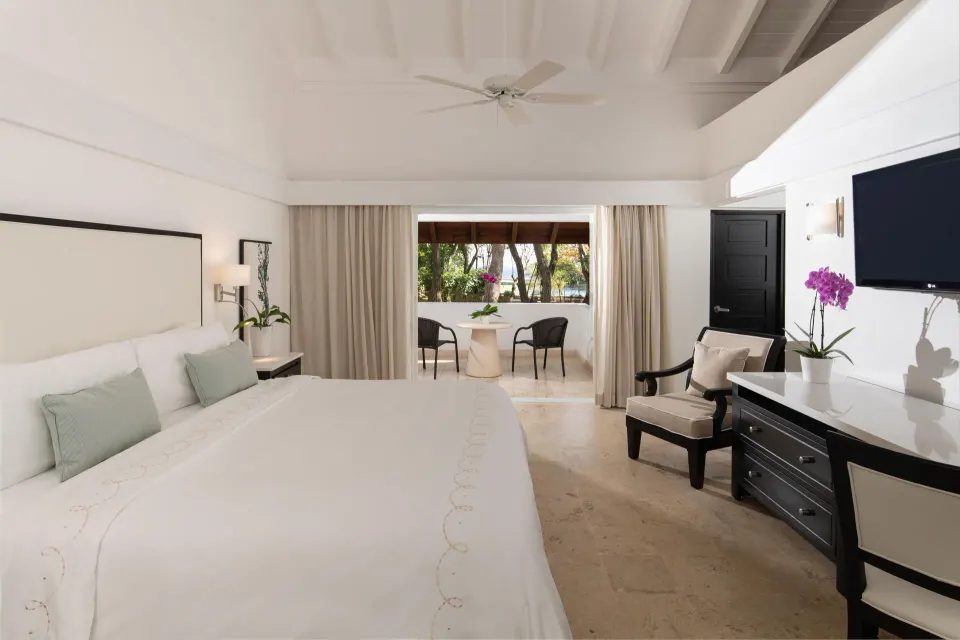 Superior Casita king bedroom opening to a furnished terrace at Casa de Campo Resort and Villas and Villas and Villas.