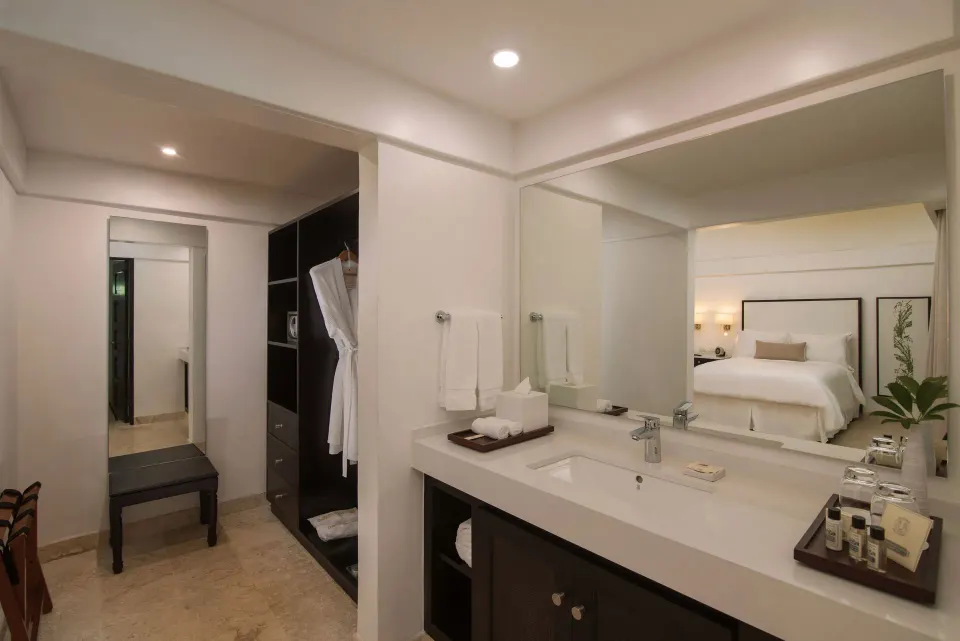 Superior Casita vanity and open closet with bedroom reflected at Casa de Campo Resort and Villas and Villas and Villas.