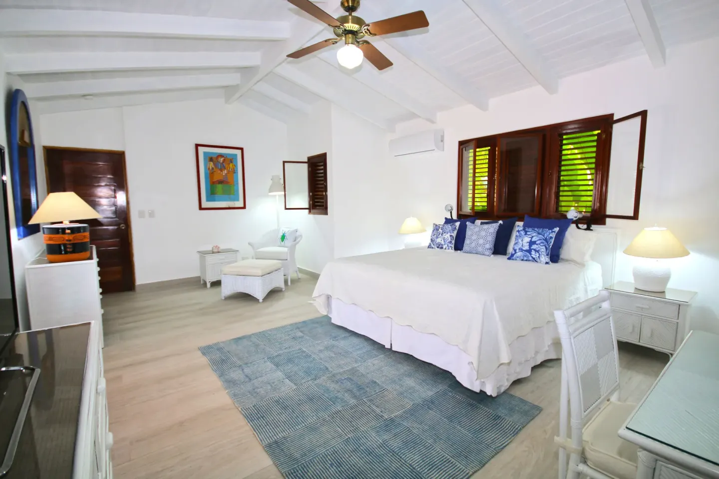 Three Bedroom Garden Villa king bedroom with white furnishings at Casa de Campo Resort and Villas.