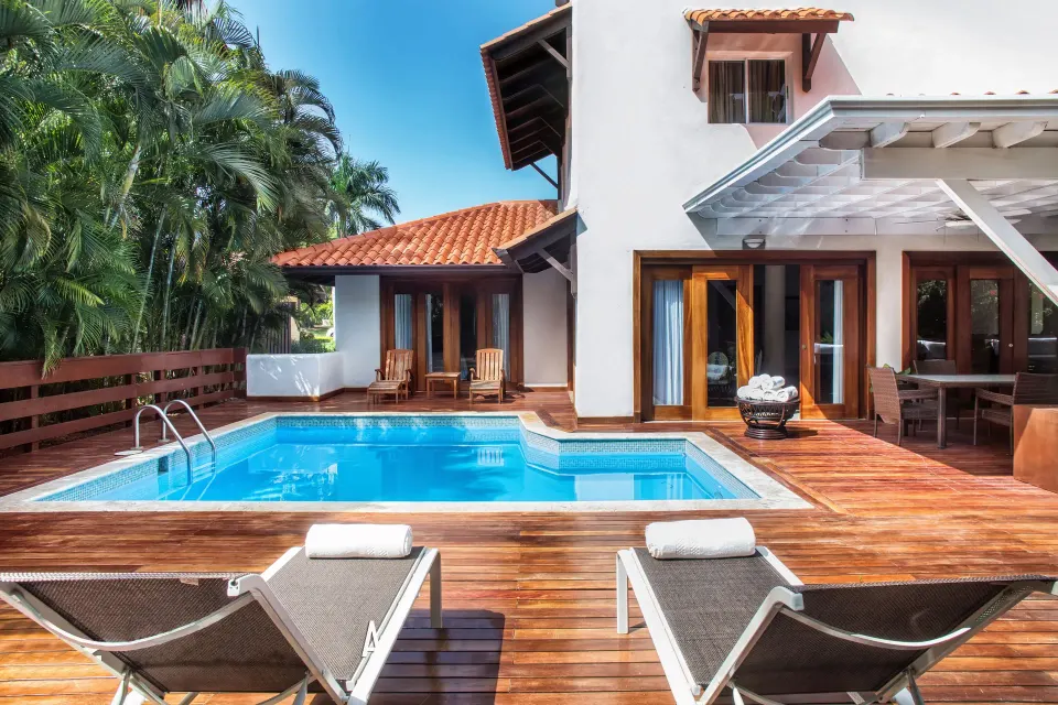 Three Bedroom Garden Villa pool deck with loungers at Casa de Campo Resort and Villas.