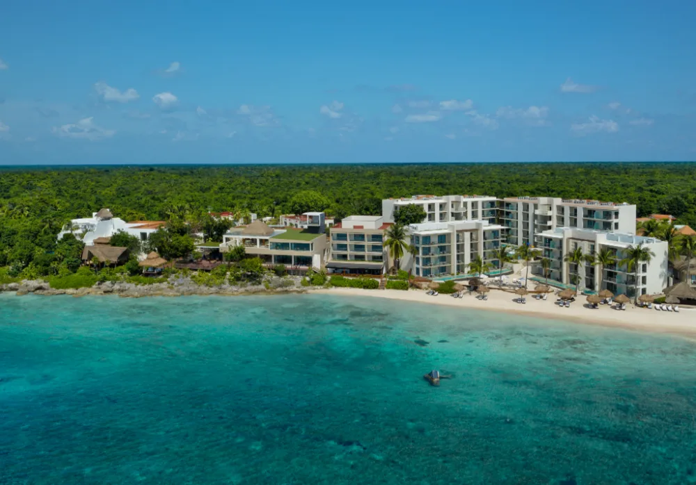 Dreams Cozumel Cape Resort & Spa family-friendly all-inclusive resort with beachfront pools and modern resort buildings in Cozumel, Mexico.