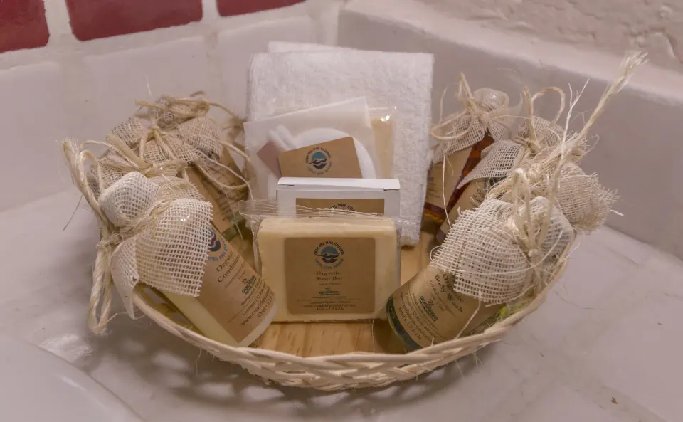 Basket of packaged bath amenities on a sink ledge at Casa del Mar Cozumel Hotel & Dive Resort