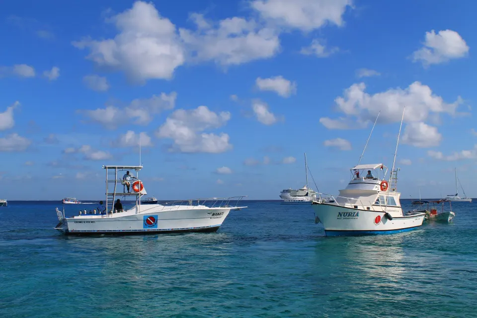 Two dive boats moored on clear water off Casa del Mar Cozumel Hotel & Dive Resort