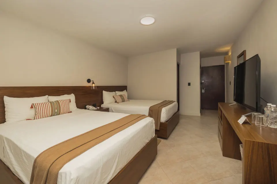 Two double beds in a guest room at Casa del Mar Cozumel Hotel & Dive Resort