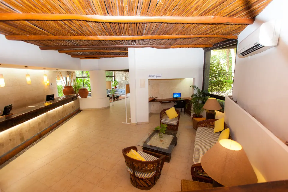 Wide view of the Casa del Mar lobby with reception desk and seating area under wooden ceiling.