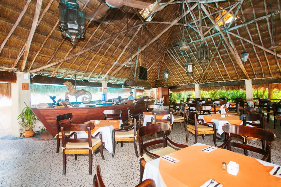 Open-air palapa restaurant dining area at Casa del Mar Cozumel Hotel & Dive Resort