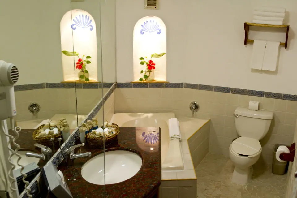 Bathroom with vanity, built-in tub and decorative niches at Casa del Mar Cozumel Hotel & Dive Resort