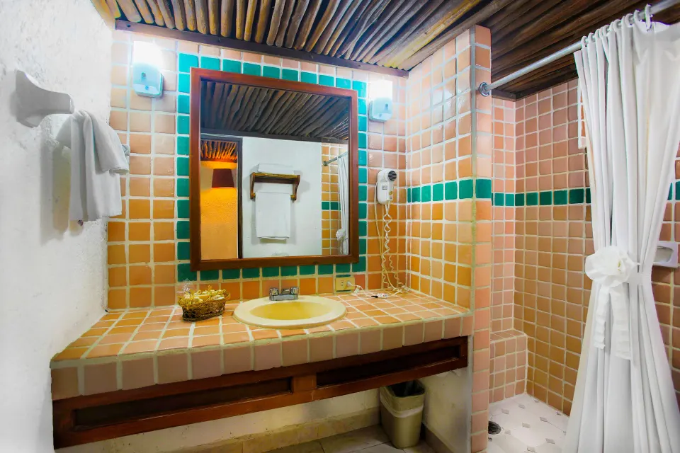 Tiled bathroom vanity and walk-in shower at Casa del Mar Cozumel Hotel & Dive Resort