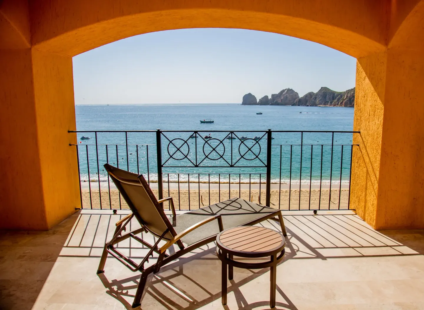 Balcony lounge chair facing the beach and ocean at Casa Dorada Los Cabos Resort & Spa.