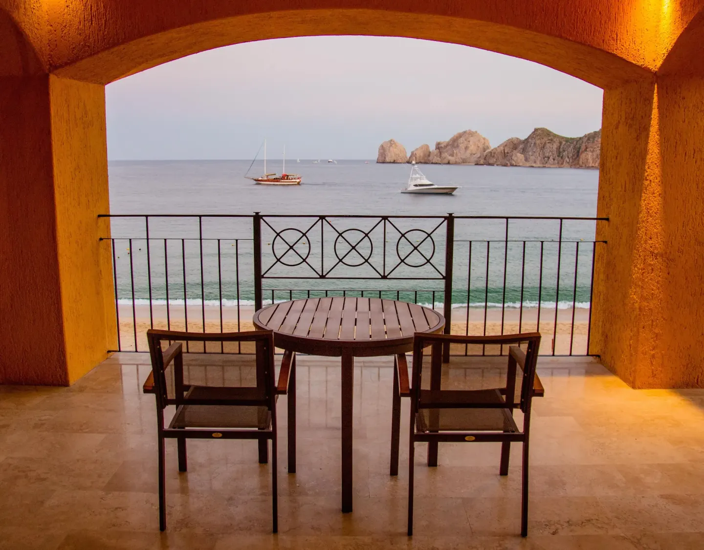 Balcony seating with boats and ocean beyond at Casa Dorada Los Cabos Resort & Spa.