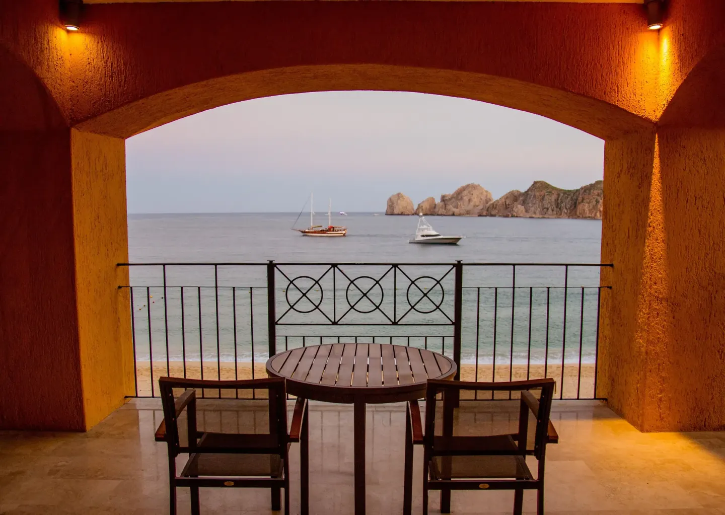 Covered balcony dining set overlooking the ocean at Casa Dorada Los Cabos Resort & Spa.