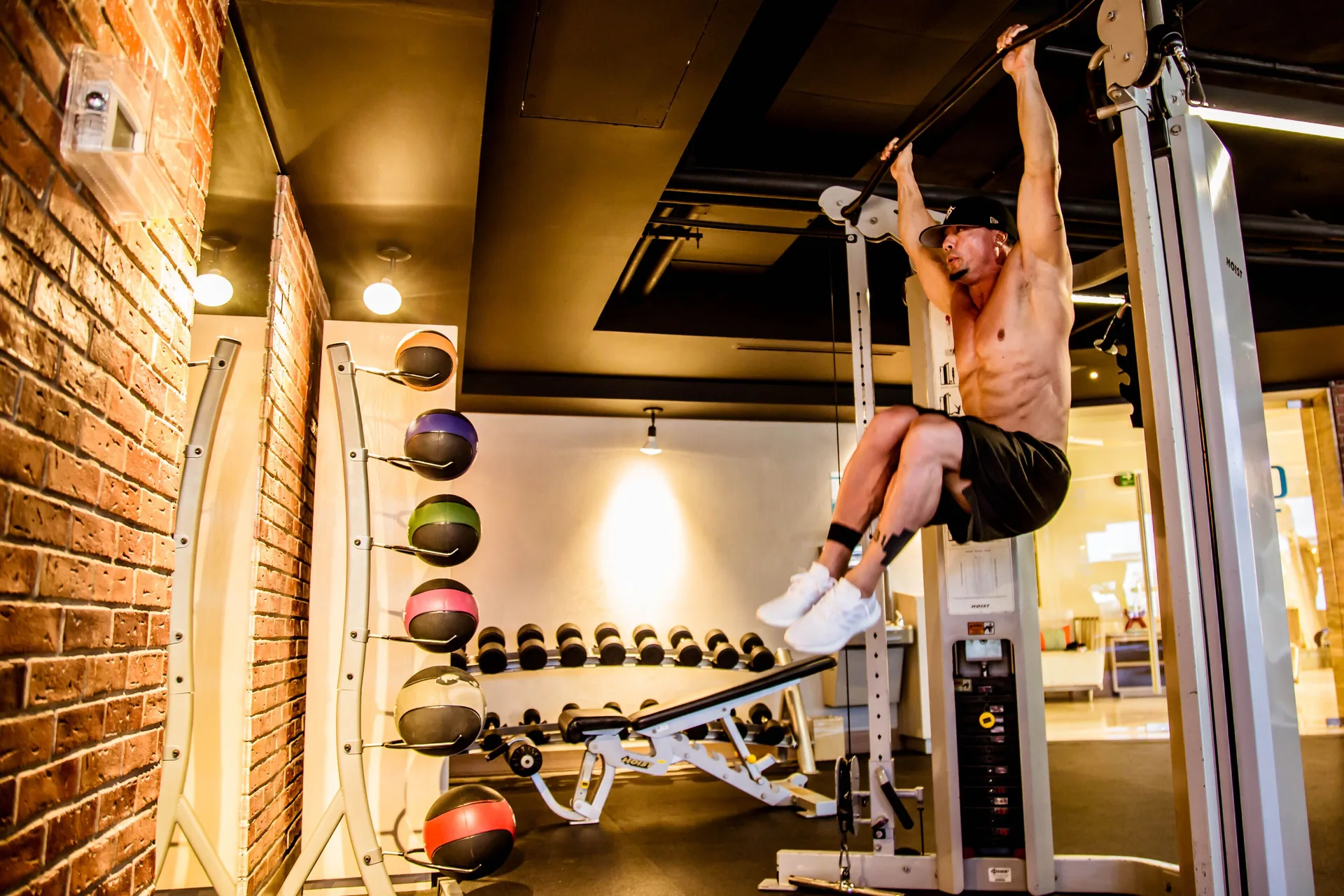 Guest using a pull-up machine in the fitness center at Casa Dorada Los Cabos Resort & Spa.