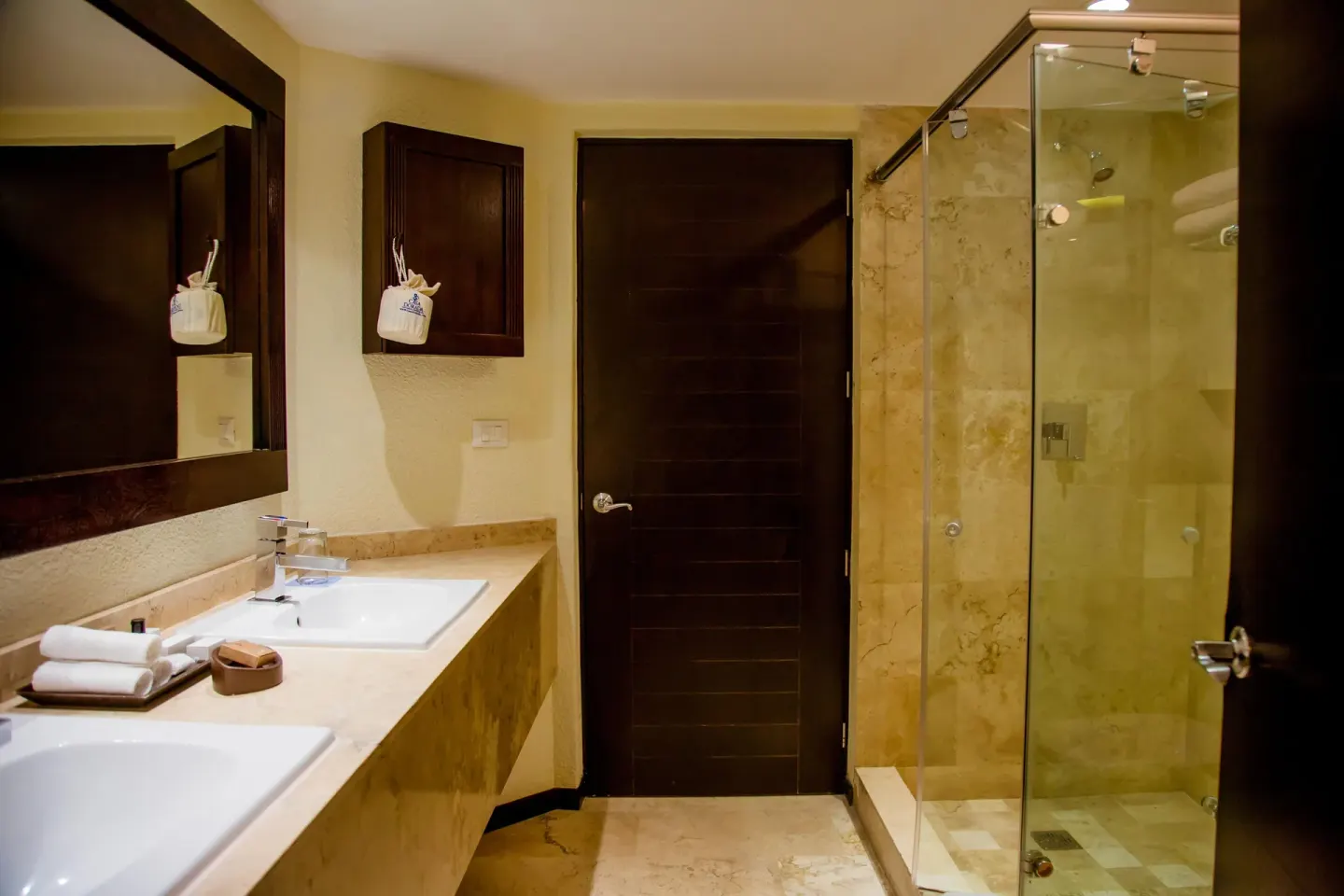 Guest bathroom with double sinks and glass shower at Casa Dorada Los Cabos Resort & Spa.