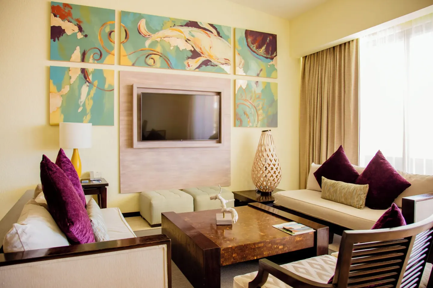 Bright lounge seating area with wall art at Casa Dorada Los Cabos Resort & Spa.