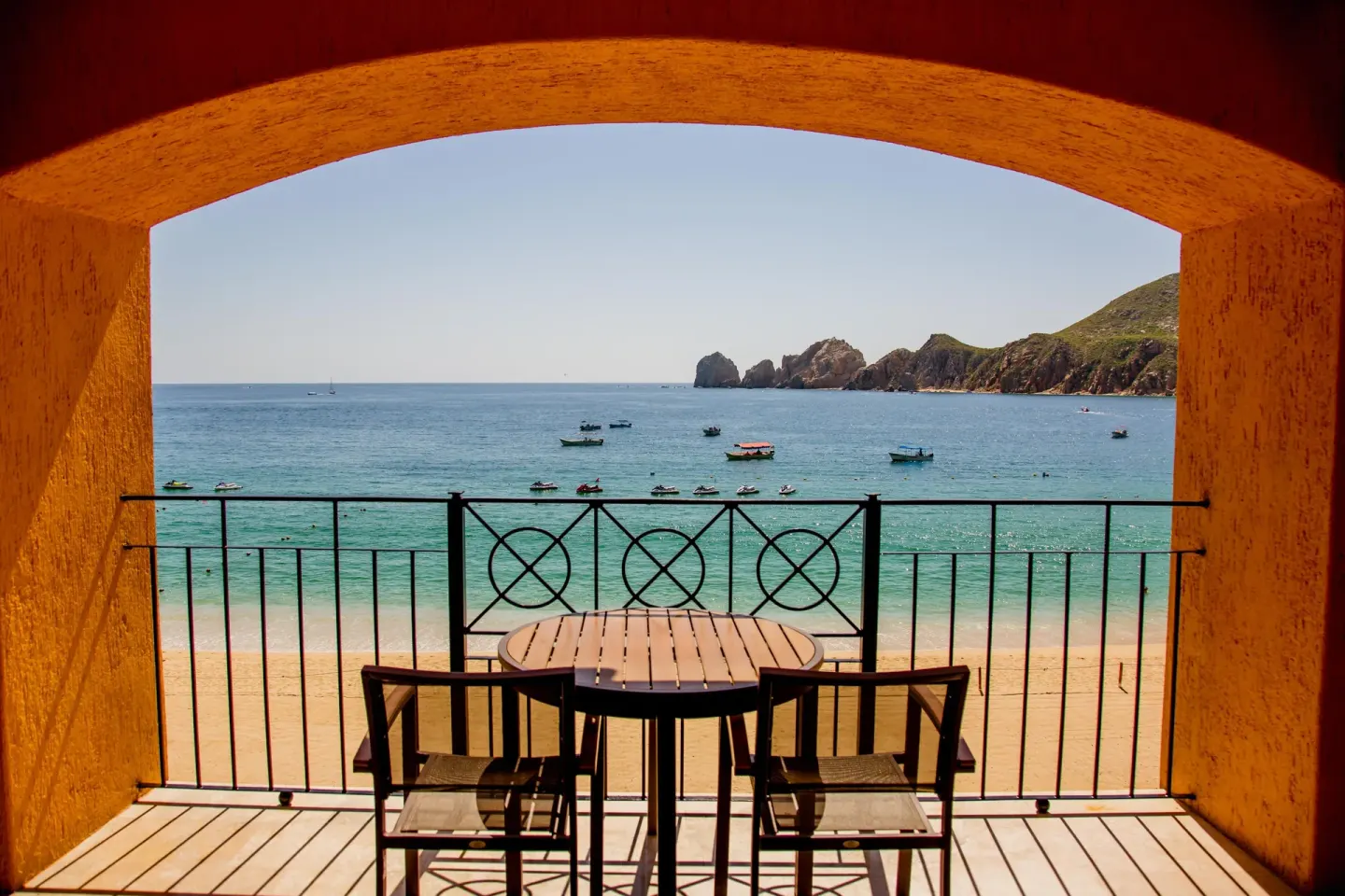 Balcony table and chairs overlooking the beach and ocean at Casa Dorada Los Cabos Resort & Spa.