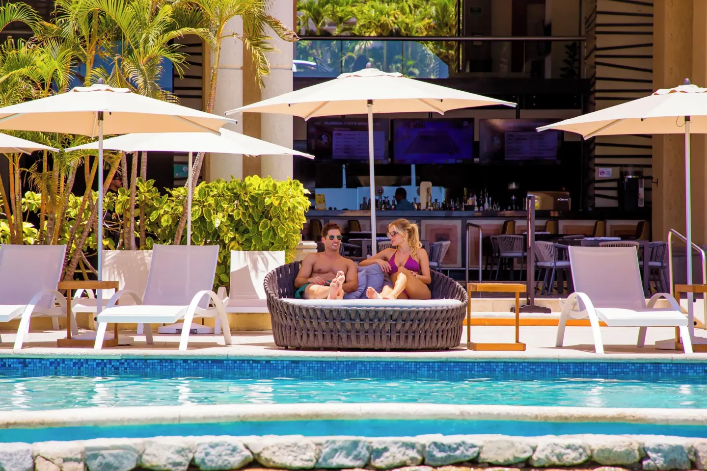 Poolside daybed and bar area at Casa Dorada Los Cabos Resort & Spa.