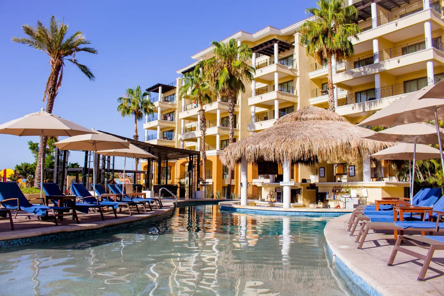 Poolside swim-up bar and loungers at Casa Dorada Los Cabos Resort & Spa.