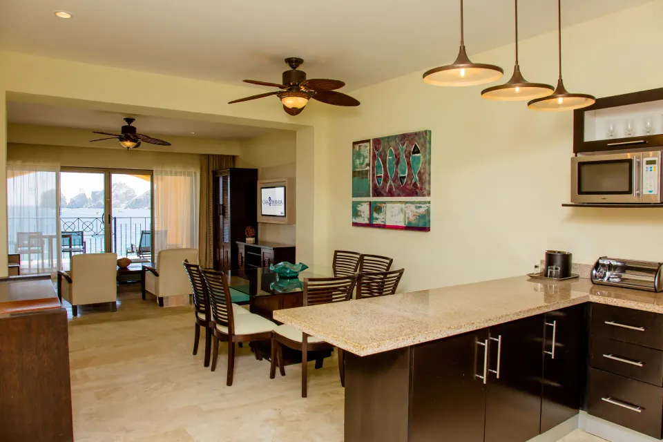 One Bedroom Suite kitchen, dining, living area and balcony at Casa Dorada Los Cabos Resort & Spa.