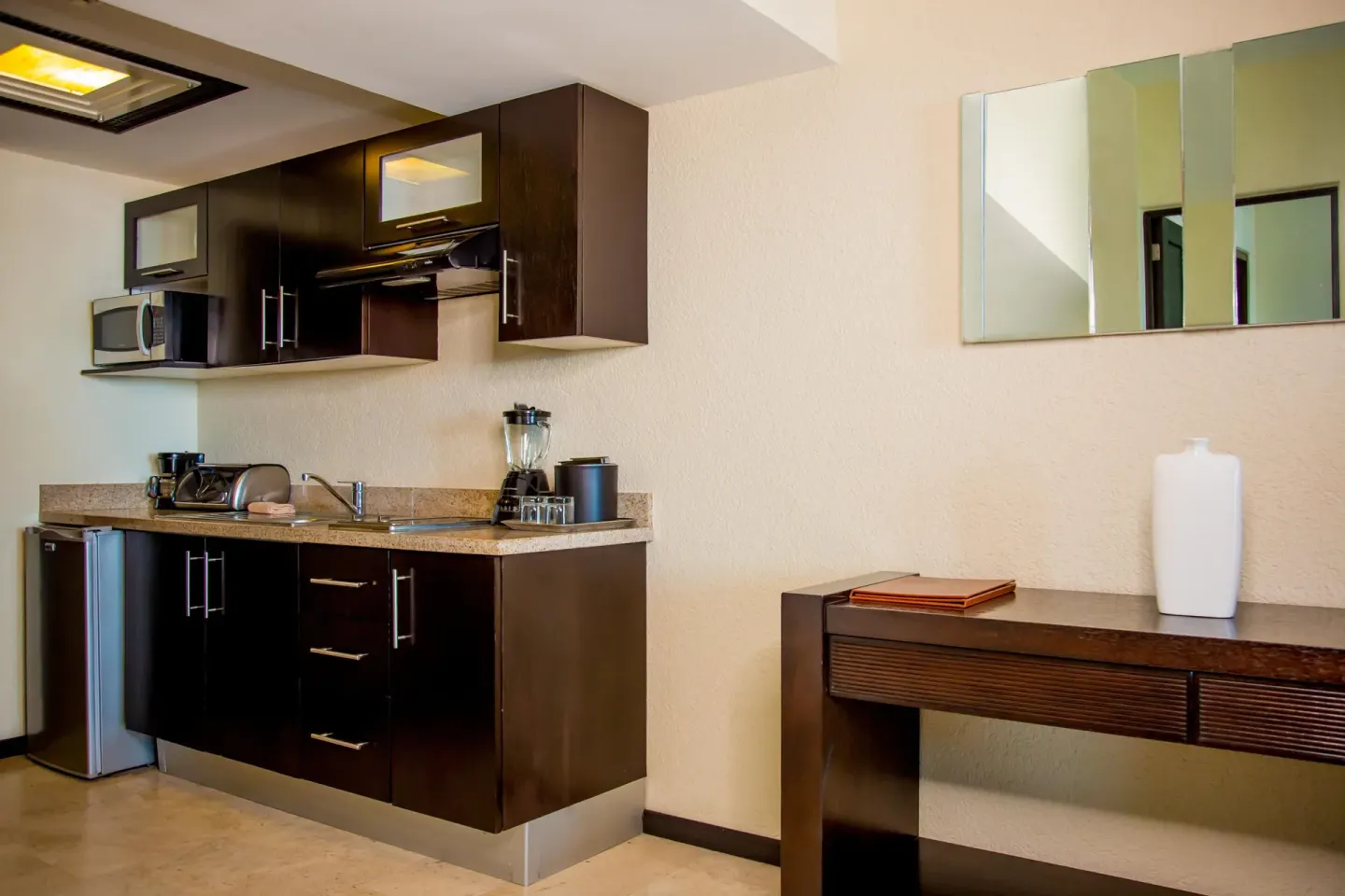 Executive suite kitchenette with cabinets and counter at Casa Dorada Los Cabos Resort & Spa.