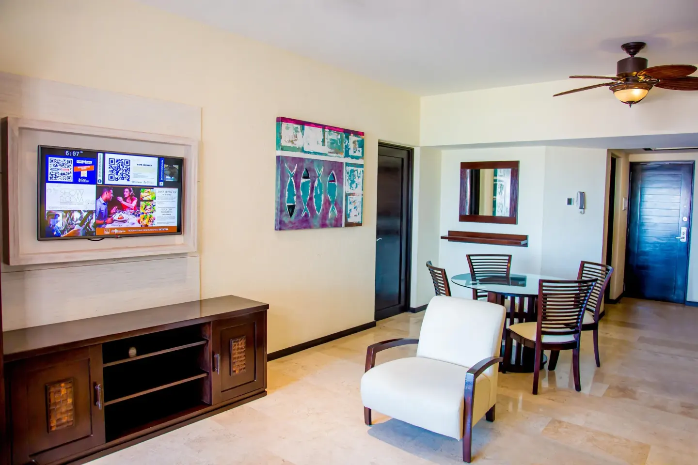 Executive suite living and dining area with TV at Casa Dorada Los Cabos Resort & Spa.