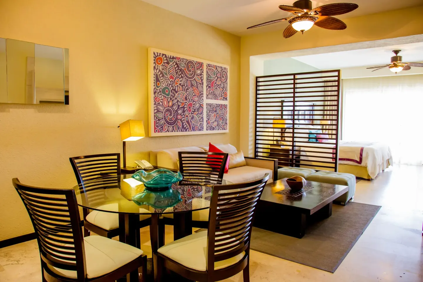 Junior suite dining and sitting area with bedroom beyond at Casa Dorada Los Cabos Resort & Spa.