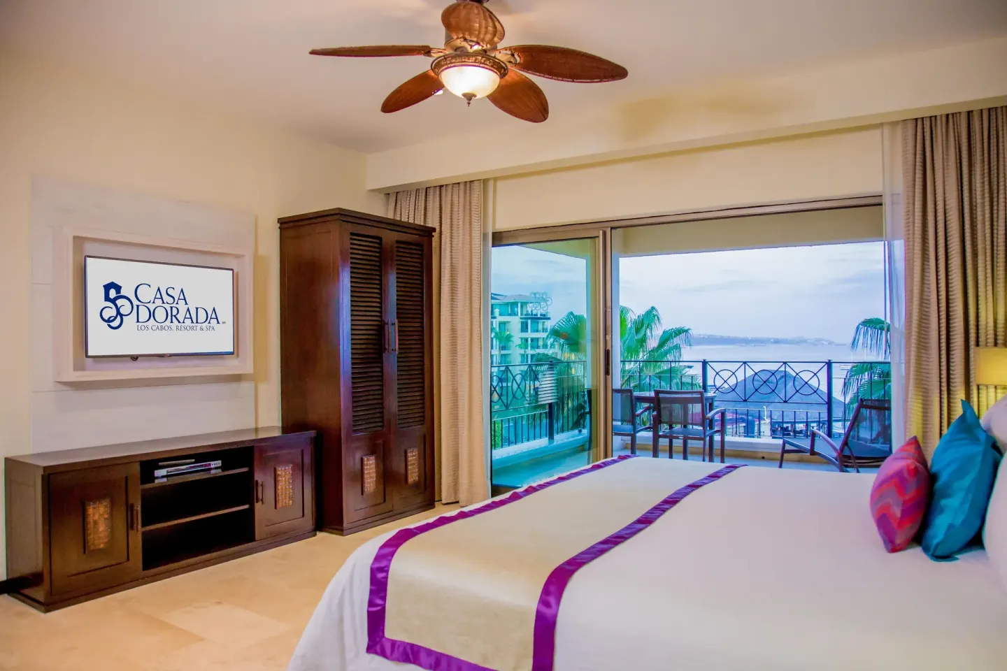 Junior suite bedroom with king bed and balcony at Casa Dorada Los Cabos Resort & Spa.
