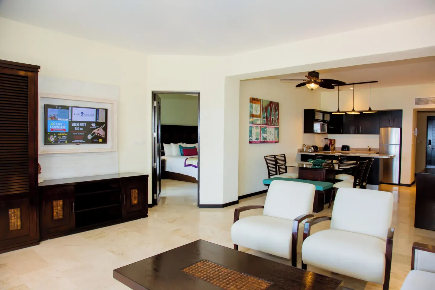 One Bedroom Plus seating area with kitchenette and bedroom beyond at Casa Dorada Los Cabos Resort & Spa.
