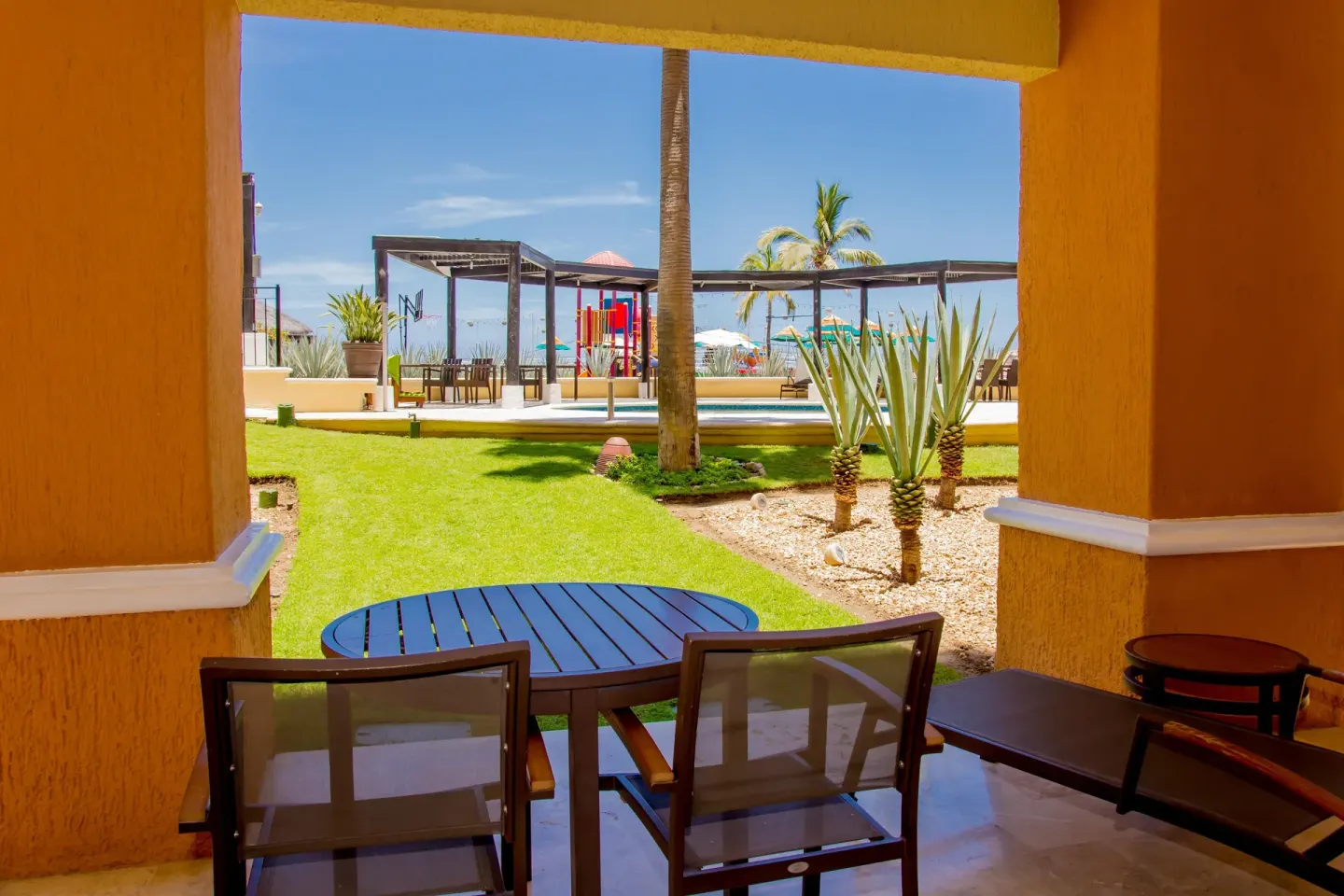Shaded garden-view patio with table and chairs at Casa Dorada Los Cabos Resort & Spa.
