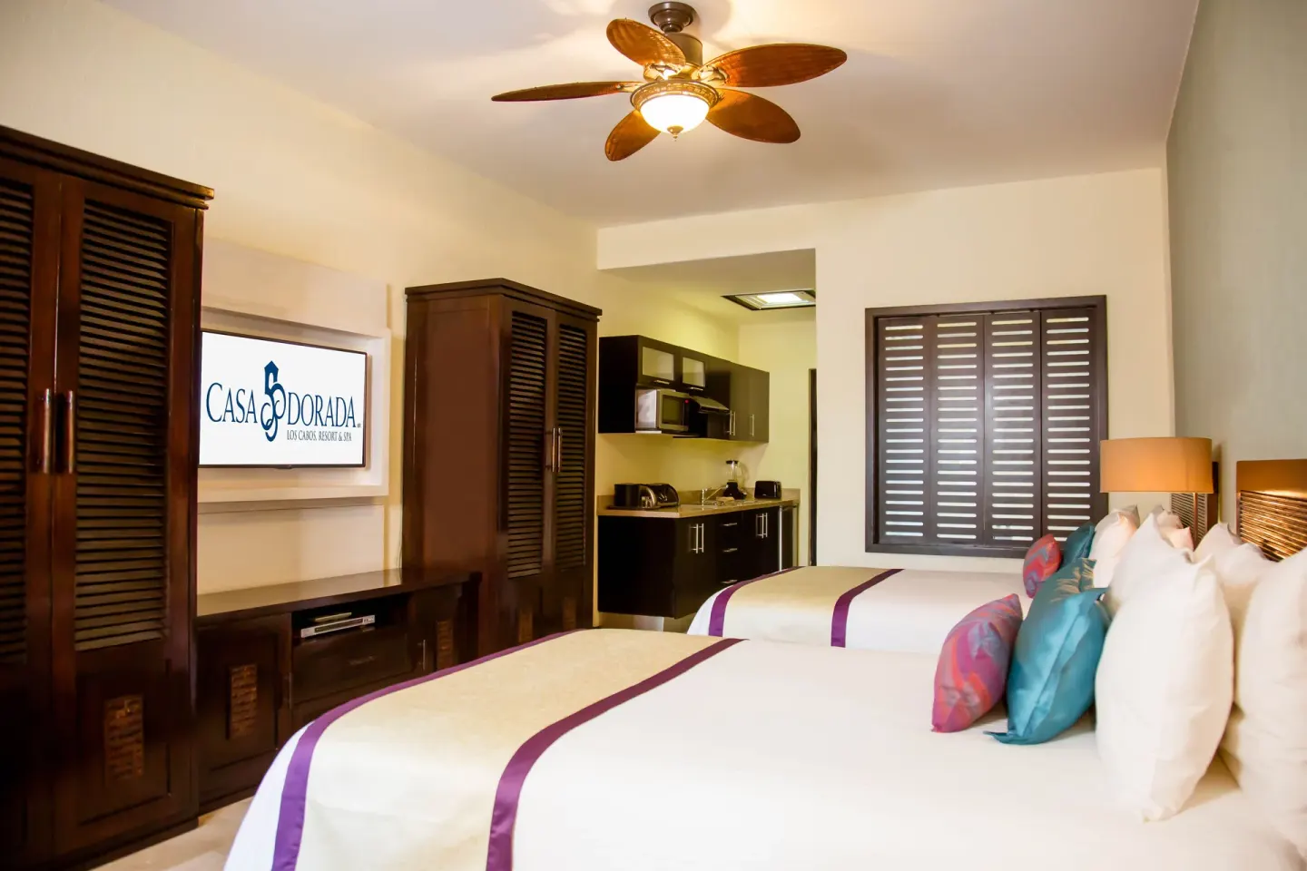 Two-bed standard room with kitchenette and TV at Casa Dorada Los Cabos Resort & Spa.