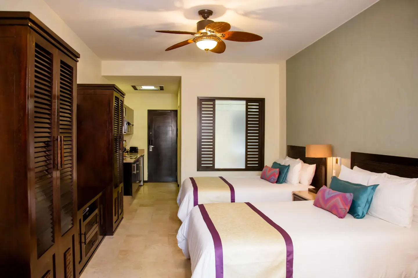 Two-bed standard room with wood cabinetry at Casa Dorada Los Cabos Resort & Spa.