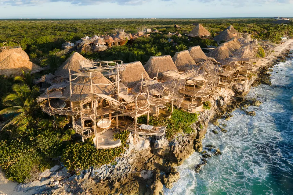 Azulik adults-only eco-luxury design resort with sculptural wooden villas and jungle canopy setting in Tulum, Mexico.