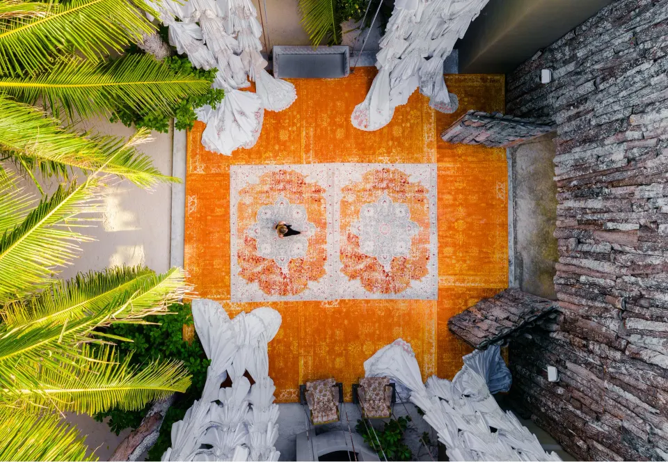 Overhead view of an orange-patterned carpeted courtyard at Casa Malca.