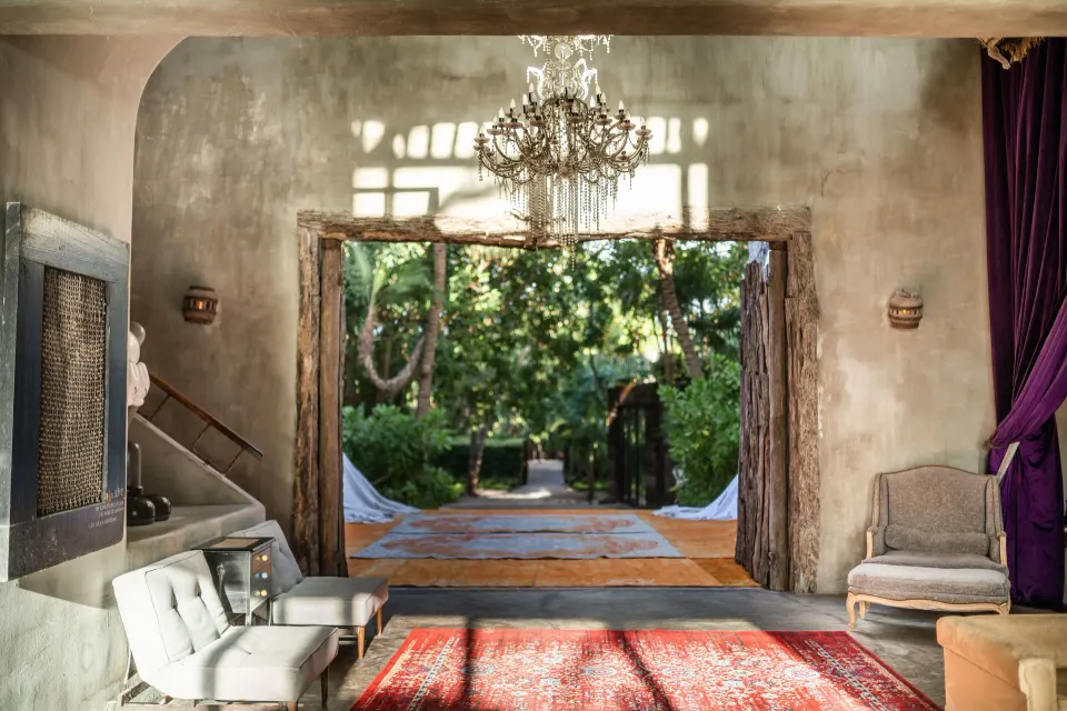 Interior doorway with chandelier looking out to garden walkway at Casa Malca.